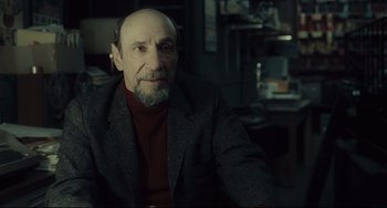 Movie still from “Inside Llewyn Davis” (2013), directed by Ethan Coen – An old man with a beard and a red sweater; Close Up shot, Over the shoulder angle