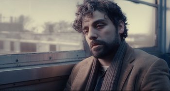 Movie still from “Inside Llewyn Davis” (2013), directed by Ethan Coen – A man with a beard is sitting on a bus; Close Up shot, Low angle