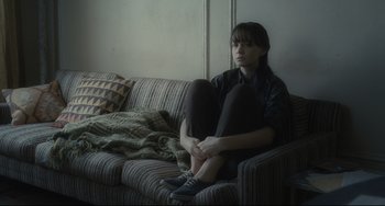 Movie still from “Inside Llewyn Davis” (2013), directed by Ethan Coen – A woman sitting on top of a couch on a sofa; Medium shot, High angle