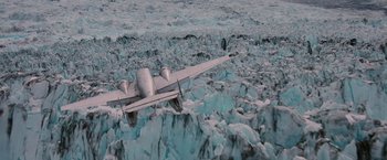 Movie still from “Insomnia” (2002), directed by Christopher Nolan – An airplane is flying over the ice in the ocean; Extreme Wide shot, Overhead angle