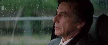 Movie still from “Insomnia” (2002), directed by Christopher Nolan – A person sitting in a car looking out the window; Close Up shot, Low angle