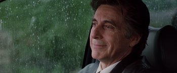 Movie still from “Insomnia” (2002), directed by Christopher Nolan – A person sitting in a car looking out the window; Close Up shot, Over the shoulder angle