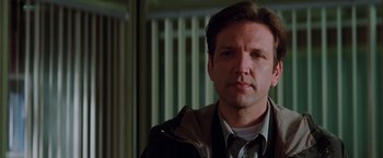 Movie still from “Insomnia” (2002), directed by Christopher Nolan – A person wearing a jacket; Close Up shot, Low angle