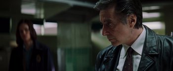 Movie still from “Insomnia” (2002), directed by Christopher Nolan – A person wearing a suit and tie; Close Up shot, Over the shoulder angle