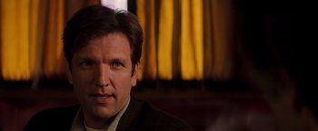 Movie still from “Insomnia” (2002), directed by Christopher Nolan – A person wearing a suit and tie; Close Up shot, Over the shoulder angle