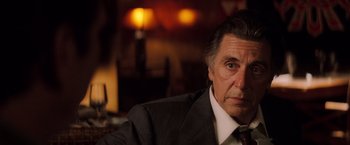 Movie still from “Insomnia” (2002), directed by Christopher Nolan – An older man wearing a suit and tie; Close Up shot, Over the shoulder angle
