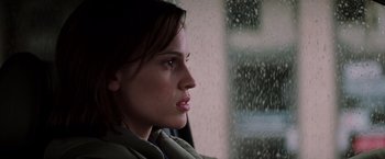 Movie still from “Insomnia” (2002), directed by Christopher Nolan – A person sitting in a car; Close Up shot, Low angle