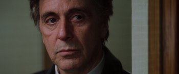 Movie still from “Insomnia” (2002), directed by Christopher Nolan – A person wearing a suit and tie; Close Up shot, Over the shoulder angle