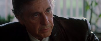 Movie still from “Insomnia” (2002), directed by Christopher Nolan – An older man wearing a leather jacket looking to his left; Close Up shot, Over the shoulder angle