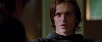 Movie still from “Insomnia” (2002), directed by Christopher Nolan – A person with long brown hair; Close Up shot, Low angle
