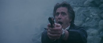 Movie still from “Insomnia” (2002), directed by Christopher Nolan – A man holding a gun in his hand; Close Up shot, Low angle