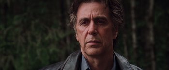 Movie still from “Insomnia” (2002), directed by Christopher Nolan – A person wearing a leather jacket; Close Up shot, Low angle