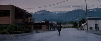 Movie still from “Insomnia” (2002), directed by Christopher Nolan – A man walking down the street in the middle of the night; Extreme Wide shot, Low angle