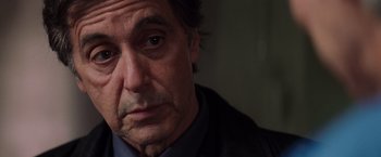 Movie still from “Insomnia” (2002), directed by Christopher Nolan – A man's face in a dark room; Close Up shot, Over the shoulder angle