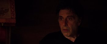 Movie still from “Insomnia” (2002), directed by Christopher Nolan – A person in a dark room; Close Up shot, Over the shoulder angle