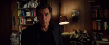 Movie still from “Insomnia” (2002), directed by Christopher Nolan – A person wearing a suit and tie; Close Up shot, Low angle