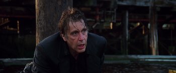 Movie still from “Insomnia” (2002), directed by Christopher Nolan – A person wearing a suit and tie; Close Up shot, Low angle