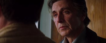 Movie still from “Insomnia” (2002), directed by Christopher Nolan – An older man is looking at the camera; Close Up shot, Over the shoulder angle