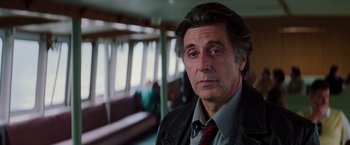 Movie still from “Insomnia” (2002), directed by Christopher Nolan – A person wearing a suit and tie; Close Up shot, Low angle