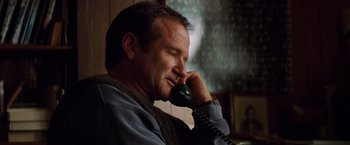 Movie still from “Insomnia” (2002), directed by Christopher Nolan – A person talking on a phone; Close Up shot, Low angle