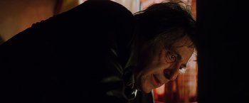 Movie still from “Insomnia” (2002), directed by Christopher Nolan – A person wearing a leather jacket; Close Up shot, Low angle