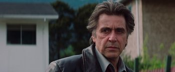 Movie still from “Insomnia” (2002), directed by Christopher Nolan – A person wearing a leather jacket; Close Up shot, Low angle