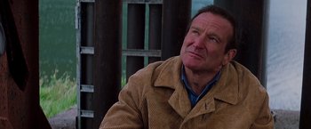 Movie still from “Insomnia” (2002), directed by Christopher Nolan – An older man wearing a corduroy jacket looking off into the distance; Close Up shot, Over the shoulder angle