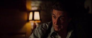 Movie still from “Insomnia” (2002), directed by Christopher Nolan – A person wearing a dress shirt; Close Up shot, Over the shoulder angle