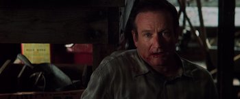 Movie still from “Insomnia” (2002), directed by Christopher Nolan – A person wearing a plaid shirt; Close Up shot, Over the shoulder angle