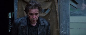 Movie still from “Insomnia” (2002), directed by Christopher Nolan – A person wearing a leather jacket; Close Up shot, High angle