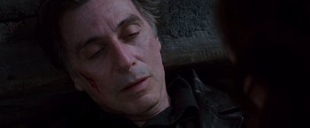 Movie still from “Insomnia” (2002), directed by Christopher Nolan – A person sleeping on the ground; Close Up shot, High angle
