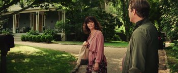 Movie still from “Irrational Man” (2015), directed by Woody Allen – A woman is walking down the street holding a bag; Medium shot, Over the shoulder angle