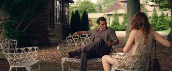 Movie still from “Irrational Man” (2015), directed by Woody Allen – A man sitting on top of a bench next to a woman; Medium shot, Over the shoulder angle