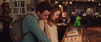Movie still from “Irrational Man” (2015), directed by Woody Allen – A man and a woman are hugging in a library; Medium shot, Over the shoulder angle
