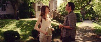 Movie still from “Irrational Man” (2015), directed by Woody Allen – A woman and a man are standing in the grass; Medium shot, Over the shoulder angle