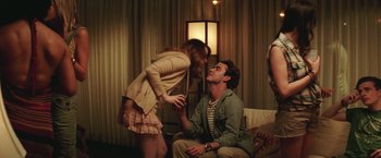 Movie still from “Irrational Man” (2015), directed by Woody Allen – A man sitting on a chair next to a woman in a room; Medium shot, Over the shoulder angle