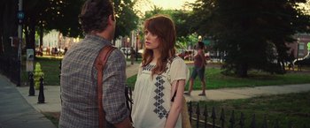 Movie still from “Irrational Man” (2015), directed by Woody Allen – A woman in a white shirt is standing next to a man; Medium shot, Over the shoulder angle