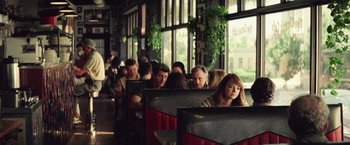 Movie still from “Irrational Man” (2015), directed by Woody Allen – A group of diners sitting at a restaurant; Medium shot, Over the shoulder angle