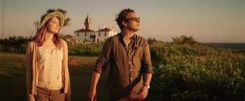Movie still from “Irrational Man” (2015), directed by Woody Allen – A man standing in a field looking up at the sky; Medium shot, Low angle