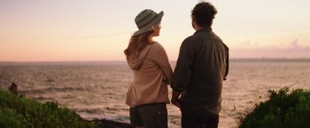 Movie still from “Irrational Man” (2015), directed by Woody Allen – A man and a woman standing next to a body of water; Medium shot, Over the shoulder angle