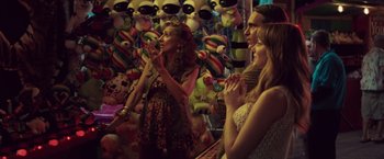 Movie still from “Irrational Man” (2015), directed by Woody Allen – A group of people standing next to each other in a room; Medium shot, Over the shoulder angle