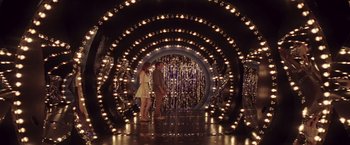 Movie still from “Irrational Man” (2015), directed by Woody Allen – A man and a woman standing in front of lights; Wide shot, Over the shoulder angle