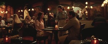 Movie still from “Irrational Man” (2015), directed by Woody Allen – A group of people sitting at a table in a restaurant; Wide shot, Over the shoulder angle