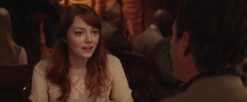 Movie still from “Irrational Man” (2015), directed by Woody Allen – A person sitting at a table; Close Up shot, Over the shoulder angle