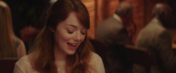 Movie still from “Irrational Man” (2015), directed by Woody Allen – A person with long brown hair; Close Up shot, Over the shoulder angle