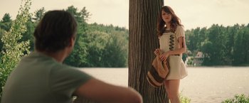 Movie still from “Irrational Man” (2015), directed by Woody Allen – A woman standing next to a tree in front of a man; Medium shot, Over the shoulder angle