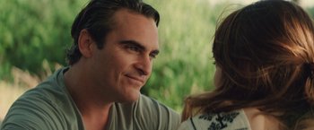 Movie still from “Irrational Man” (2015), directed by Woody Allen – A person sitting next to another person; Close Up shot, Over the shoulder angle