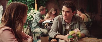 Movie still from “Irrational Man” (2015), directed by Woody Allen – A group of people sitting at a table with food; Medium shot, Over the shoulder angle