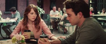 Movie still from “Irrational Man” (2015), directed by Woody Allen – A man and a woman sitting at a table with a coffee cup; Medium shot, Over the shoulder angle