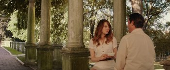 Movie still from “Irrational Man” (2015), directed by Woody Allen – A woman sitting on a bench in front of a tree; Medium shot, Over the shoulder angle